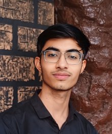 Nikunj Indoriya, head and shoulders, wearing glasses and a dark shirt
